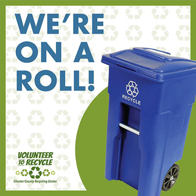Blue Recycling Cart with "We're on a Roll!" Notice
