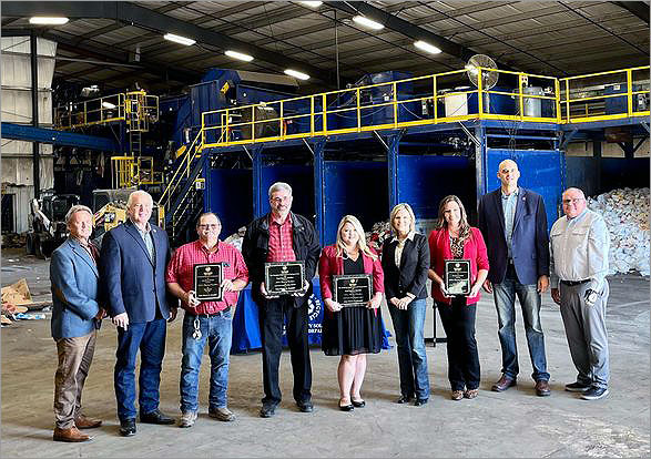 Recycling group showing awards